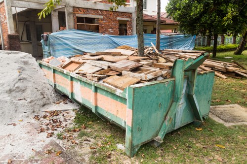 A row of skips at an Abbey Wood site with recycling signage