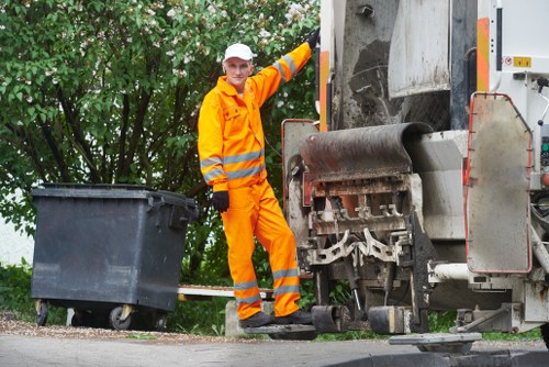 Crew performing safe loading practices at a site with safety barriers